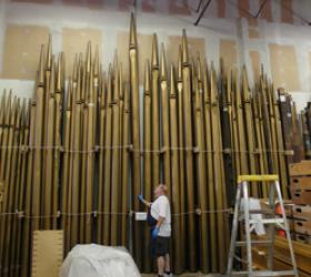Richard Cote examines façade pipes in storage at Foley-Baker facility