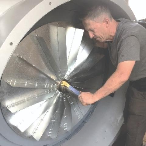 Joe Sloane installing new fans in a large organ blower