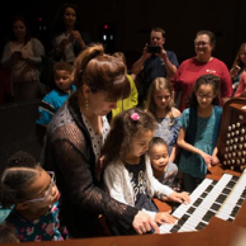 Thévenot with children at the Aeolian-Skinner console